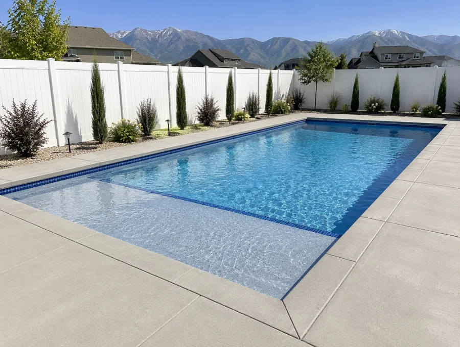 Finished gunite pool with tanning ledge, bench seating, and waterline tile